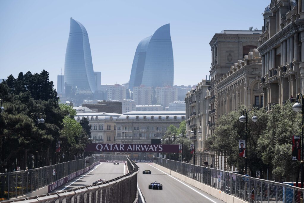 F1 cars in front of Qatar Airways F1 sponsor branding